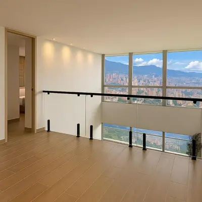 an empty room with a view of a city at El Poblado Amazing Penthouse with Breathtaking Views in Medellín