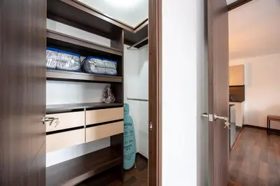 a room with a closet with wooden shelves and a door at Apartamentos Casa Grande in Rionegro