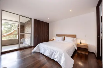 a bedroom with a large bed and a large window at Apartamentos Casa Grande in Rionegro