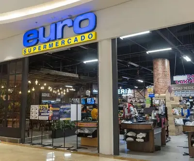 a store with a sunoco super americota sign in a store at Apartamentos La Frontera in Medellín