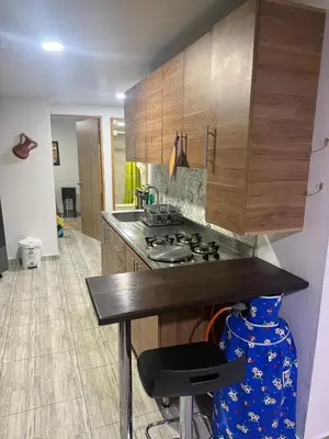 a kitchen with a stove and wooden cabinets at Finca el salvador in Envigado