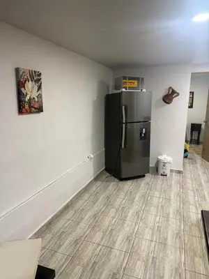 a kitchen with a black refrigerator in a room at Finca el salvador in Envigado