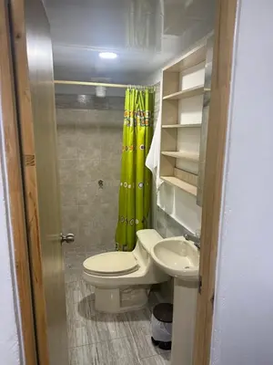 a small bathroom with a toilet and a sink at Finca el salvador in Envigado