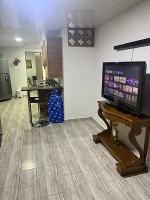 a living room with a flat screen tv on a table at Finca el salvador in Envigado