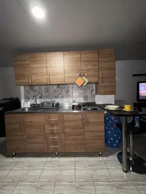 a kitchen with wooden cabinets and a table at Finca el salvador in Envigado