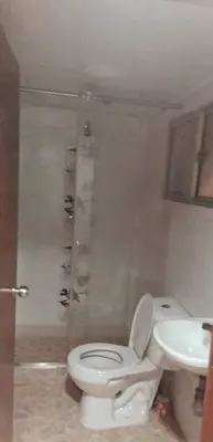a bathroom with a toilet and a sink at Cómodo apartamento por días in Manizales