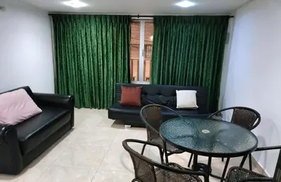 a living room with a couch and a table and chairs at Cómodo apartamento por días in Manizales