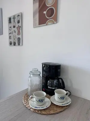 a table with two cups and a coffee maker at Sabaneta, aparta Loft, excelente Ubicacion, Wifi in Sabaneta