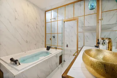 a bathroom with a tub and a sink at Lleras Vibex Party in Medellín