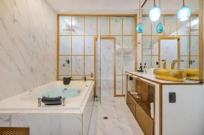 a bathroom with a tub and a sink at Lleras Vibex Party in Medellín