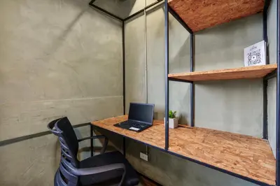 a desk with a laptop on top of it at Lleras Vibex Party in Medellín