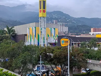 a building with a mcdonalds sign in front of a city at Quiet space near Nórdica with parking in Bello