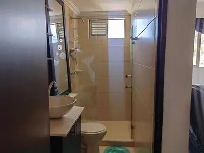 a bathroom with a sink and a toilet and a shower at Quiet space near Nórdica with parking in Bello