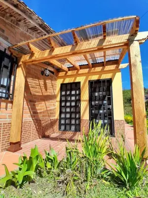 a pergola over a patio of a house at Villa El Colibri in El Peñol