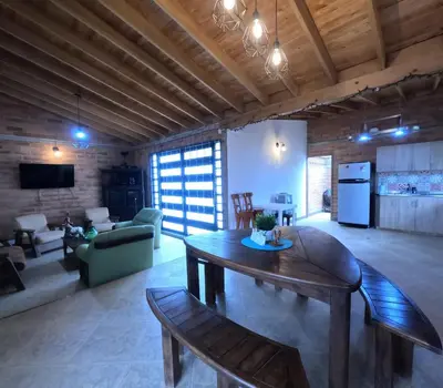 a living room with a table and a couch at Villa El Colibri in El Peñol
