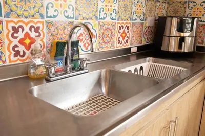 a kitchen sink with a strainer in it at Villa El Colibri in El Peñol