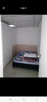 a small room with a bed in a white room at Casa estrella in Manizales