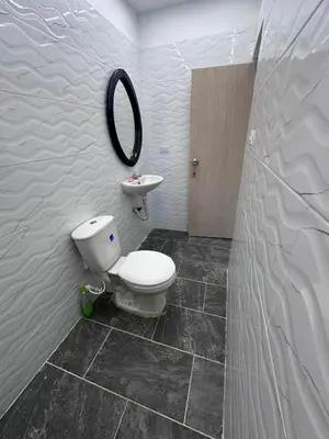 a bathroom with a toilet and a sink and a mirror at Hermoso y acogedor apartamento in Medellín