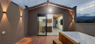 a large bathroom with a tub and a large window at Apartamento en Santa Fe de Antioquia con jacuzzi in Santa Fe de Antioquia