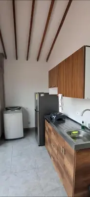 a kitchen with a sink and a refrigerator at Apartamento en Santa Fe de Antioquia con jacuzzi in Santa Fe de Antioquia