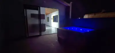 a dark room with a tub with blue lights at Apartamento en Santa Fe de Antioquia con jacuzzi in Santa Fe de Antioquia