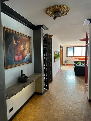 a hallway with a painting of fruit on the wall at As Seen On Netflix NARCO house in Medellín