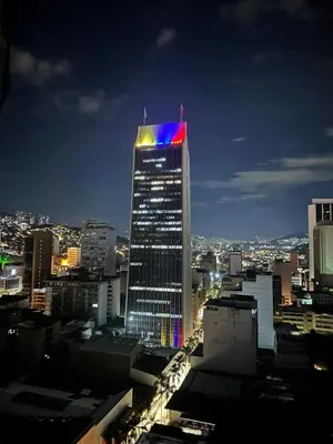 a tall building with a flag on top of it at As Seen On Netflix NARCO house in Medellín