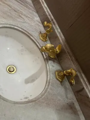 a bathroom sink with gold faucets on a counter at As Seen On Netflix NARCO house in Medellín