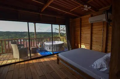 a bedroom with a jacuzzi tub on a deck at Cabañas naturales cerca a la hacienda Nápoles in Doradal