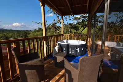a patio with a table and chairs on a deck at Cabañas naturales cerca a la hacienda Nápoles in Doradal