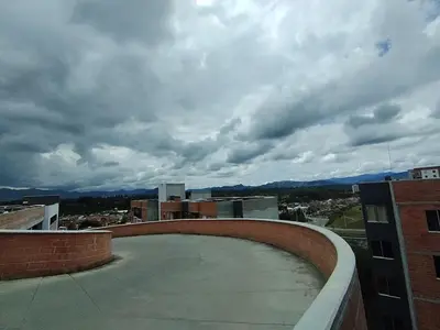 a view from the roof of a building with a cloudy sky at Confortable Apartamento cerca Aerop JMC in Rionegro