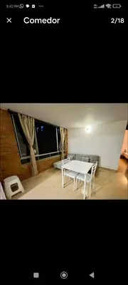 a white table and chairs in a room at Apartamento en excelente ubicación en el Poblado para renta con estadía mínima de 1 mes in Medellín
