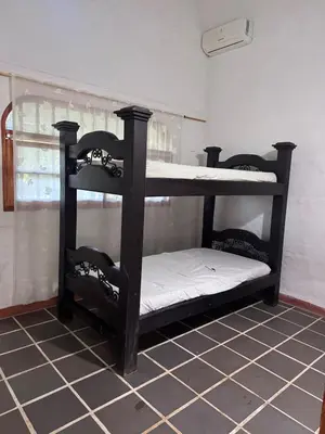 a black bunk bed in a room at Finca Doradal descanso, vacaciones or teletrabajo in Doradal