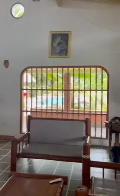 a bench sitting in a room with a window at Finca Doradal descanso, vacaciones or teletrabajo in Doradal