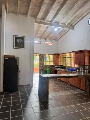 a kitchen with a black refrigerator in a room at Finca Doradal descanso, vacaciones or teletrabajo in Doradal