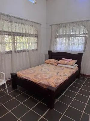 a bedroom with a large bed with curtains at Finca Doradal descanso, vacaciones or teletrabajo in Doradal