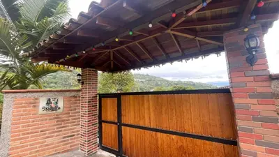 a wooden garage door with a wooden gate at La Isabella - Descanso & Naturaleza in Estación El Salto