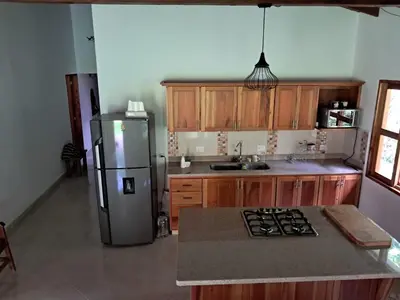 a kitchen with a refrigerator and a counter top at La Isabella - Descanso & Naturaleza in Estación El Salto