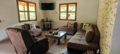 a living room with couches and a coffee table at La Isabella - Descanso & Naturaleza in Estación El Salto
