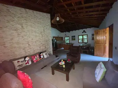 a living room with a couch and a table at La Isabella - Descanso & Naturaleza in Estación El Salto