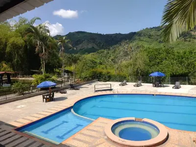a swimming pool with a view of a mountain at Finca Hotel Rancho Cattleya in Chinchiná