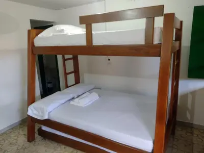 two bunk beds in a room with a mirror at Finca Hotel Rancho Cattleya in Chinchiná