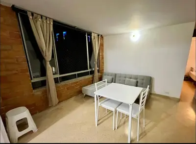 a white table and chairs in a room with a window at El mejor sector del Poblado para estancia mínima de 1 mes in Medellín