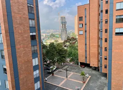 a view from between two tall buildings at El mejor sector del Poblado para estancia mínima de 1 mes in Medellín