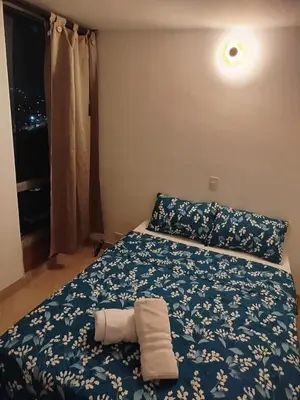 a bedroom with a bed with two towels on it at El mejor sector del Poblado para estancia mínima de 1 mes in Medellín