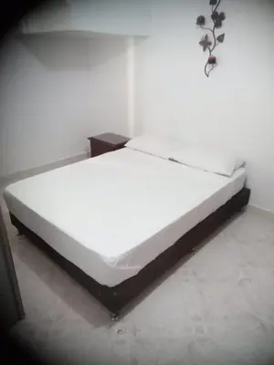 a large white bed in a room with at Habitación central con cama doble #1 in Medellín