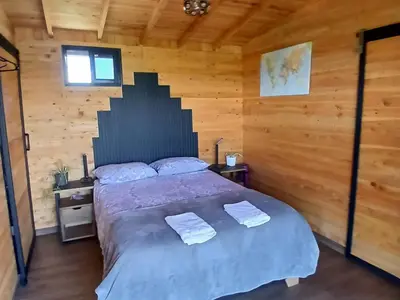a bedroom with a bed with two towels on it at Cabaña Martina in Marinilla