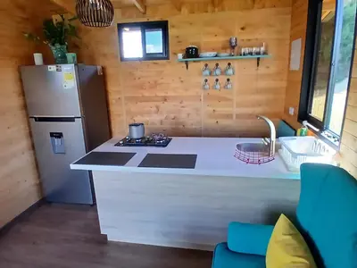 a kitchen with a refrigerator and a counter top at Cabaña Martina in Marinilla