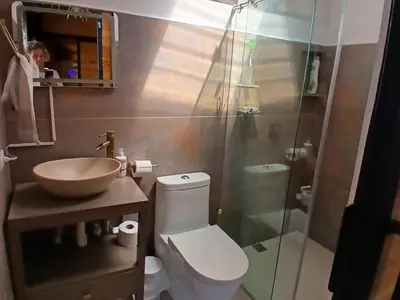 a bathroom with a toilet and a sink and a shower at Cabaña Martina in Marinilla
