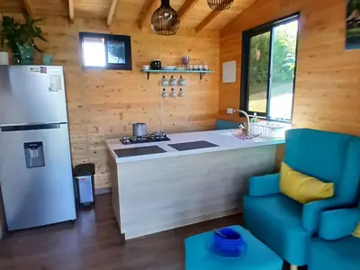 a kitchen with a refrigerator and a stove at Cabaña Martina in Marinilla